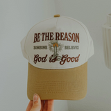 Close-up of tan and cream hat with “Be the Reason Someone Believes God is Good” embroidered design.