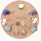 Assorted sports-themed stud earrings displayed on a white background, featuring designs like baseballs, mitts, and caps.