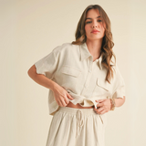 Woman wearing cropped natural linen short sleeve button-up shirt