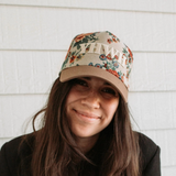 Front-facing view of woman in YHWH embroidered floral cap with neutral tones.