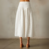 Outfit styled with sandals and cropped white tank.