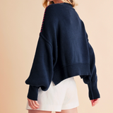 Back view of oversized USA navy sweater showing drop shoulders and red whipstitch detail