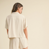 Side angle showing the linen shirt’s length and texture