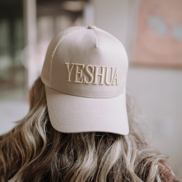 Front view of the "Yeshua" 5-panel hat showcasing navy puff embroidery on the brown cap.