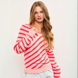 Model wearing the Cross Stripe V Neck Sweater Top, showcasing the flattering V-neckline and relaxed fit in pink and red stripes.