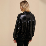 Back view of Sequin Button-Down Top highlighting the glossy sequin finish and long sleeves with buttoned cuffs.