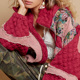 Back view of an oversized quilted jacket with a hood and floral patchwork design in a vibrant red tone.