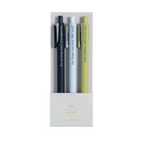 Faith-based pens writing spiritual phrases in ink, laid out on a flat-lay with a notepad.

