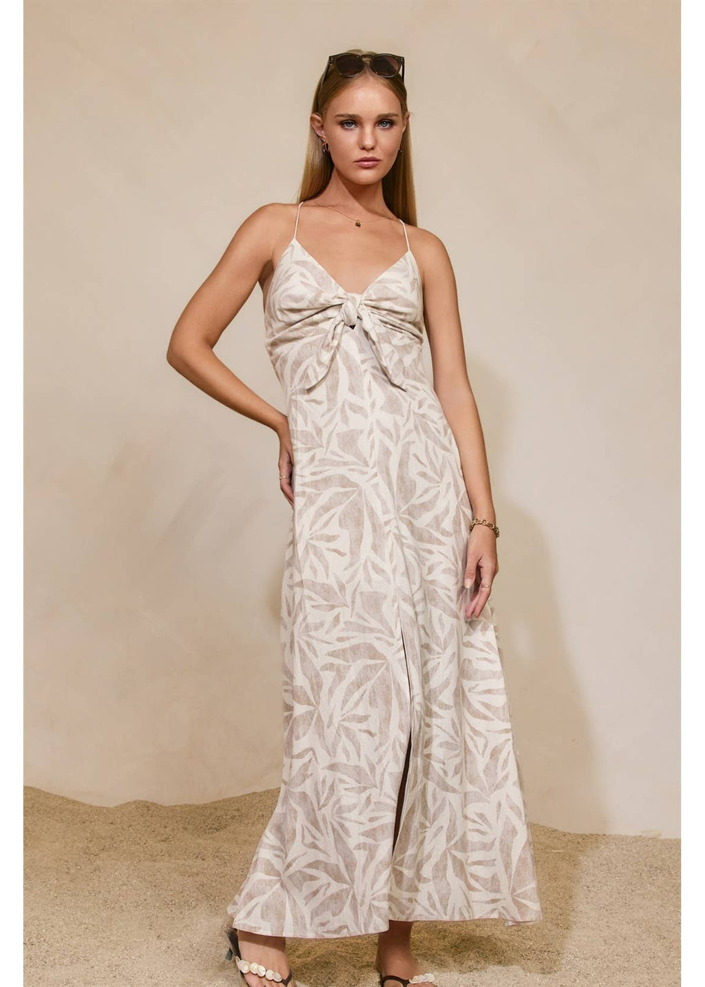 Woman wearing a floral dress against a neutral background