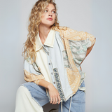 Model wearing oversized patchwork kimono top with wide sleeves, denim and paisley detail, and light wash patchwork pants.