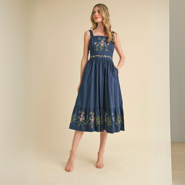 Model wearing navy blue embroidered midi dress, full front view.
