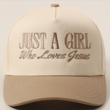 Beige and tan embroidered "Just A Girl Who Loves Jesus" trucker hat front view.