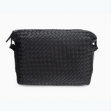 Black woven leather toiletry bag with sleek design, perfect for organizing grooming essentials for travel or daily use.