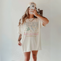 Front view of 'Freedom Set Us Free' oversized graphic tee in ivory.