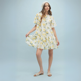 Front View: A lemon-print mini dress with adjustable bow straps and a flowy A-line silhouette.
