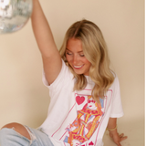 Close-up of the Queen of Hearts Graphic Tee on a smiling model, showcasing the vibrant card-themed design on soft white cotton.