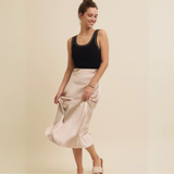 Model holding the Satin Bias-Cut Maxi Skirt for a playful touch, showcasing the flowing silky texture and beautiful fit.