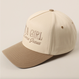 Side view of "Just A Girl Who Loves Jesus" hat with beige crown and tan bill.