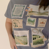 "Faith-inspired t-shirt worn by model featuring scenic and scripture print stamps"

