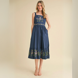 Front-facing view of navy midi dress with floral embroidery and pockets.