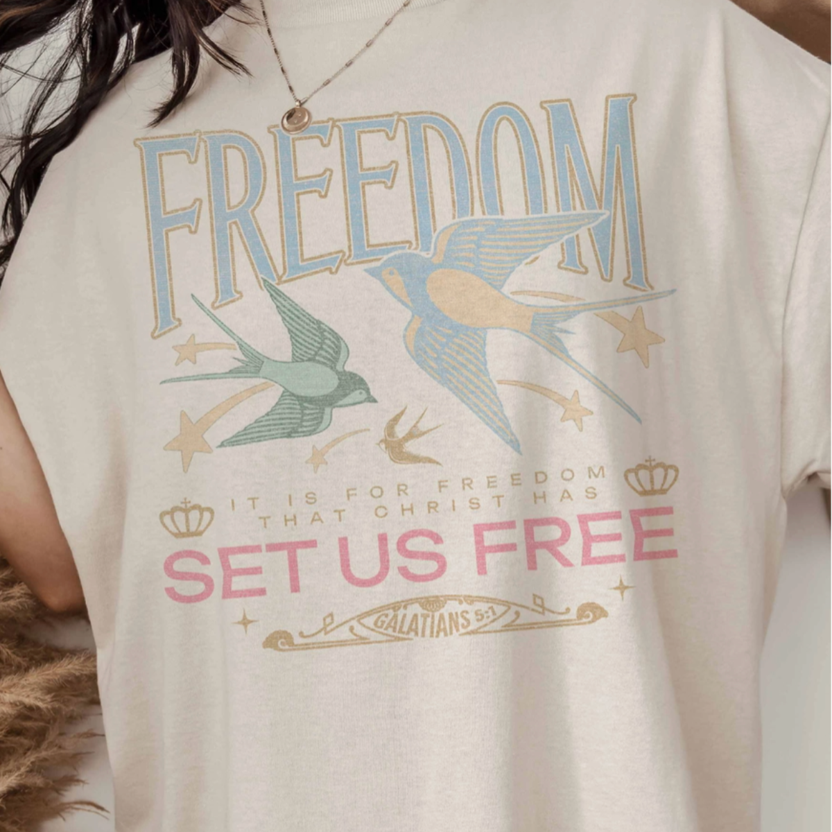 Close-up of 'Freedom Set Us Free' graphic design on the tee.​
