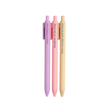 Faith-based pens writing spiritual phrases in ink, laid out on a flat-lay with a notepad.

