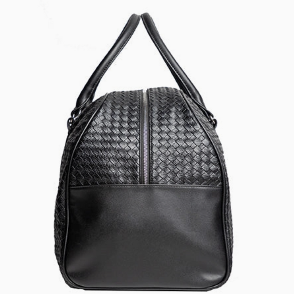Side view of black woven leather travel duffel bag showing durable leather panel and sleek zip closure.