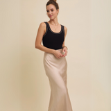 Model posing in the Satin Bias-Cut Maxi Skirt, showing its luxurious heavy satin fabric and bias-cut design.