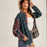 "Side angle of western-style flannel shirt with red, green, and tan plaid patterns"

