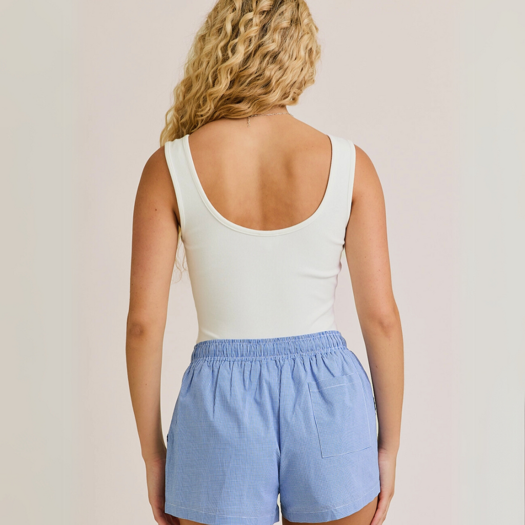 Back view of white ribbed bodysuit with low scoop back

