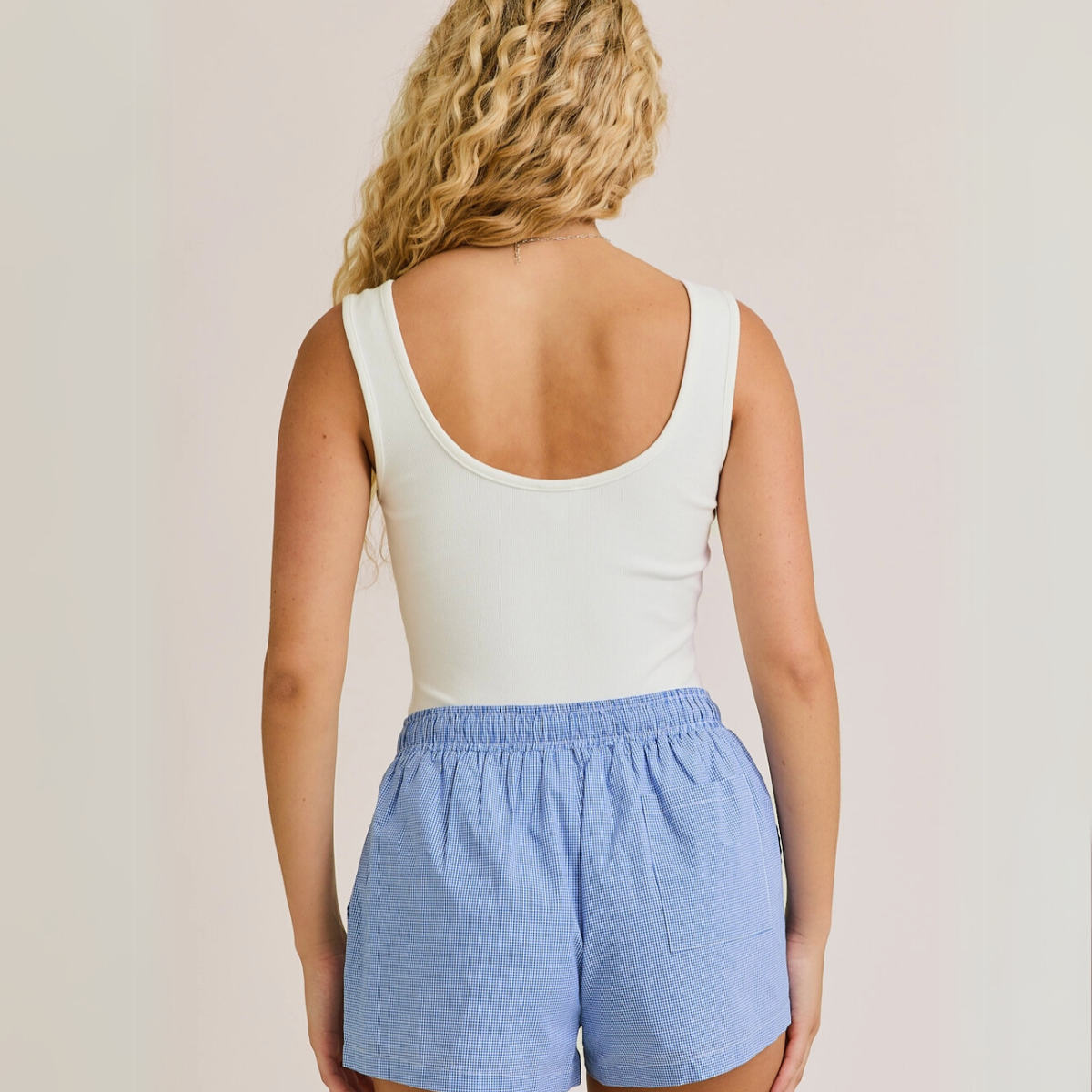 Back view of white ribbed bodysuit with low scoop back

