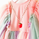 A child wearing the Kids' Strawberry Charm Necklace, highlighting its fit and playful appearance.


