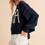 Side profile of USA knit pullover with red stitching detail on shoulder

