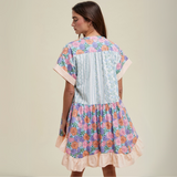 Rear angle of the dress featuring a tiered structure with floral and striped patterns.