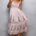 Pink embroidered dress on a plain background