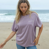 Full outfit shot of the t-shirt styled with jeans on the beach.