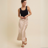 Model wearing the Satin Bias-Cut Maxi Skirt paired with a black tank top, highlighting its flattering silhouette and versatile style.