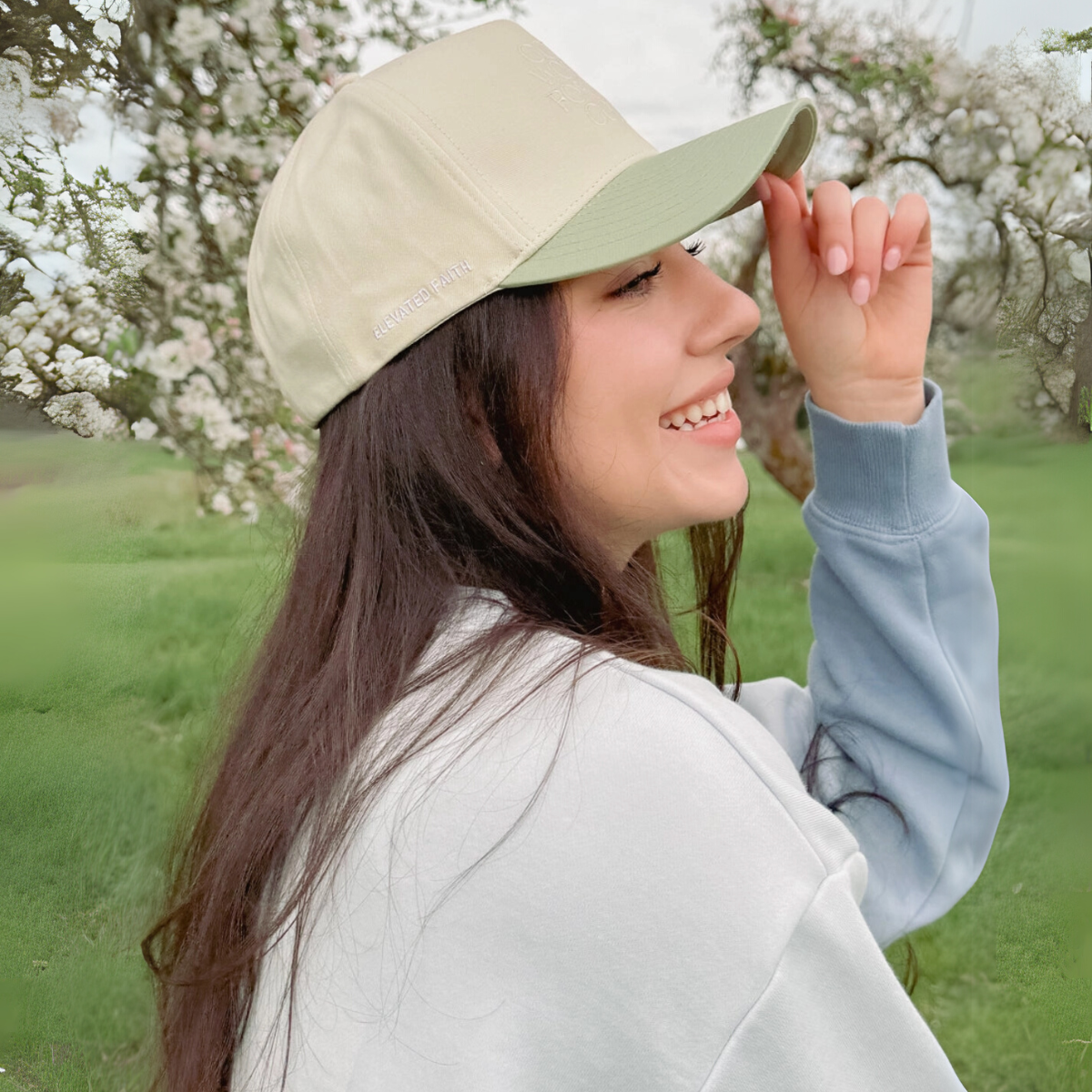 "Side profile of a woman wearing the 'God Works for the Good' baseball cap, showing the embroidered design and adjustable fit."

