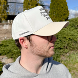 Side view of the cap worn by a man, featuring "Elevated Faith" embroidered on the side panel.