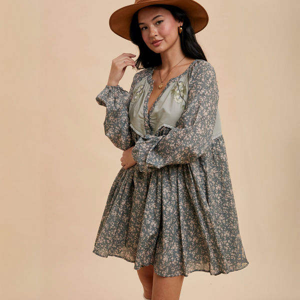 Full view of model wearing Floral Embroidered Babydoll Dress styled with a wide-brim hat, highlighting its boho-inspired aesthetic.