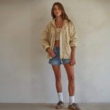 Model wearing the All Good Washed Jacket paired with denim shorts, showcasing its casual quilted design and mineral wash.