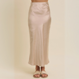 Front view of the Satin Bias-Cut Maxi Skirt in a sleek champagne tone, showcasing its smooth texture and elegant drape.