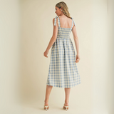 Back view of gingham dress showing smocked elastic and full skirt

