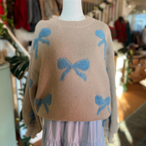 Styled look of the Ribbon Pattern Balloon Sleeve Sweater on a mannequin paired with a flowy blue skirt, perfect for fall or winter fashion.