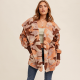 Model showcasing the cozy camo hooded jacket from the front, highlighting the open-front style.