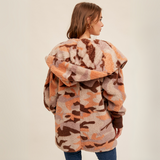 Back view of the cozy camo hooded jacket featuring a relaxed fit and bold camouflage print.