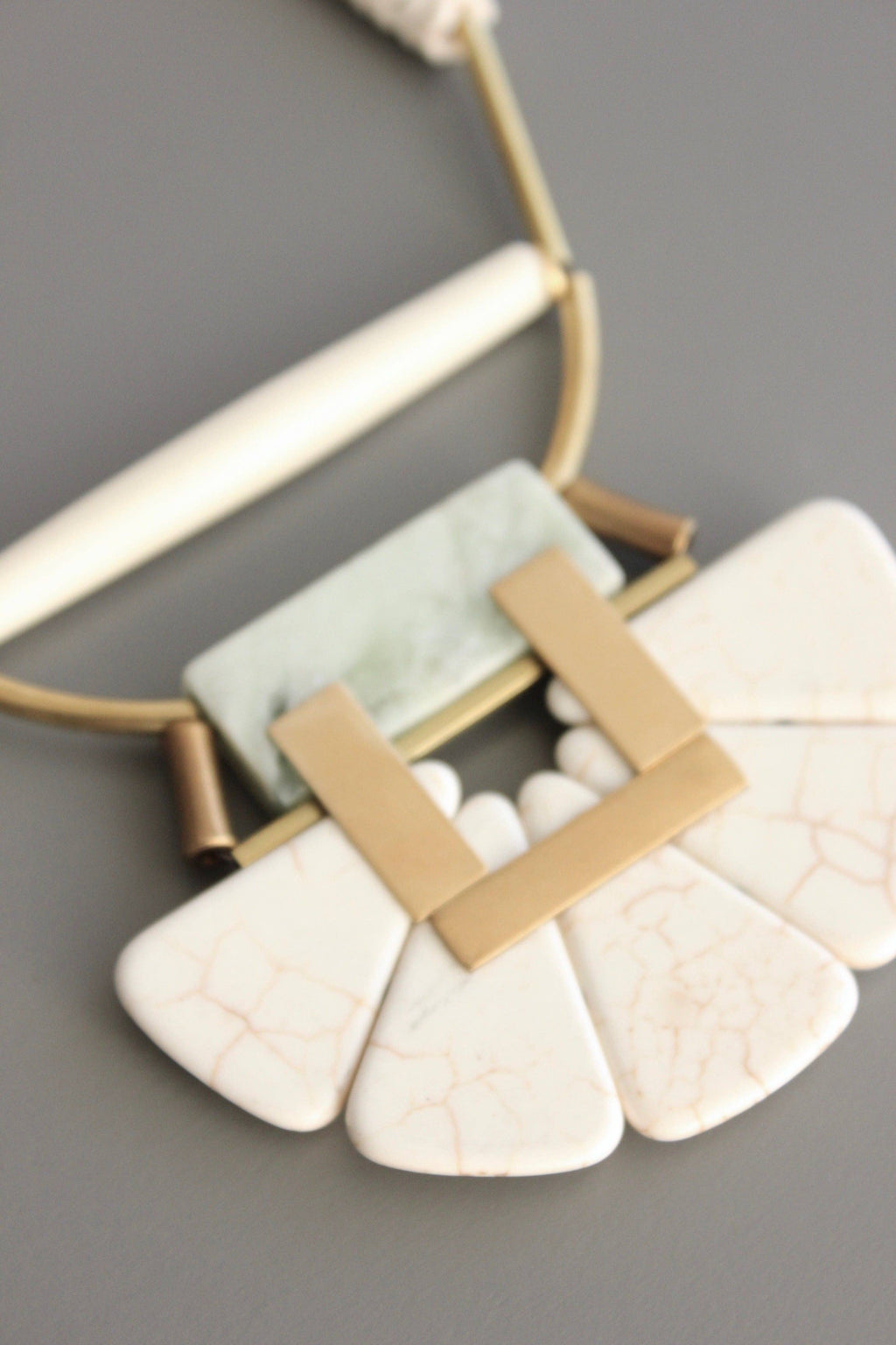 Magnesite, horn, serpentine, and brass necklace