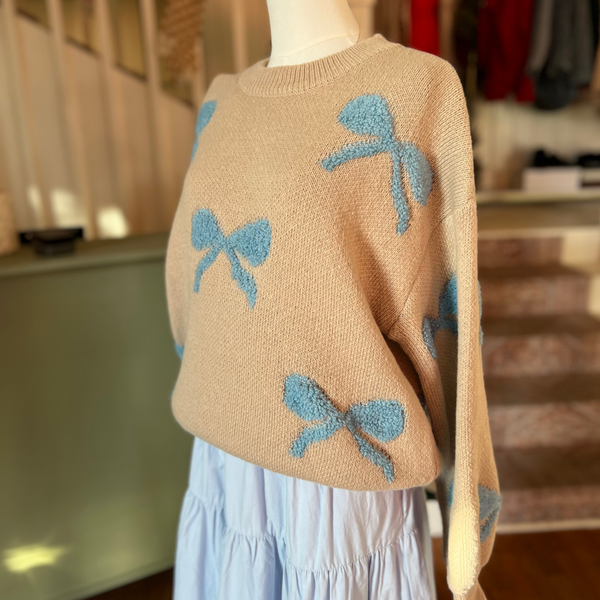 Styled look of the Ribbon Pattern Balloon Sleeve Sweater on a mannequin paired with a flowy blue skirt, perfect for fall or winter fashion.