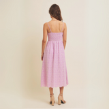 Back view of midi dress showcasing smocked detail and flowing skirt.