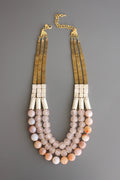 Triple strand necklace with hematite, magnesite, fire agate, glass, and brass